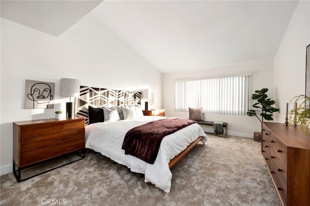 carpeted bedroom with vaulted ceiling