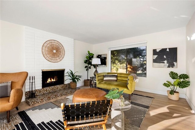 living room featuring hardwood / wood-style flooring and a fireplace