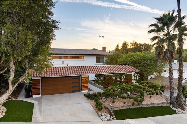 7385 Darnoch Way, West Hills, CA 91307 - view of front of house with concrete driveway, a garage, and a tile roof