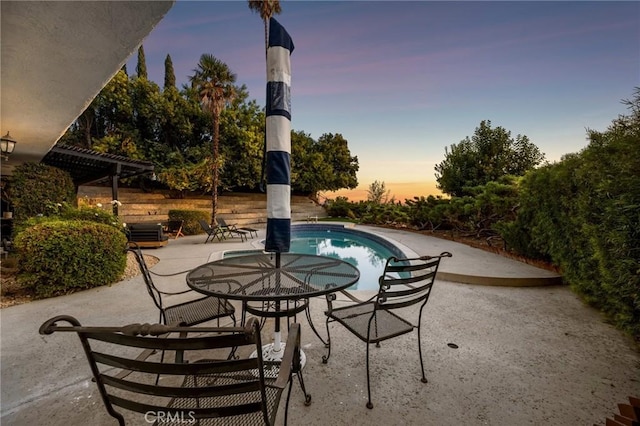 patio terrace at dusk with a pergola