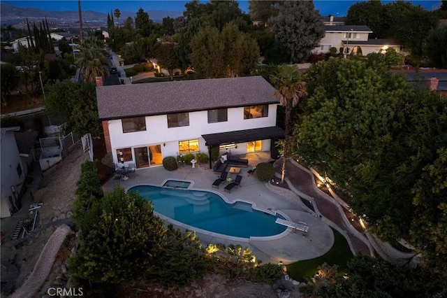 7385 Darnoch Way, West Hills, CA 91307 - rear view of house with a fenced backyard, a patio, a pool with connected hot tub, and stucco siding