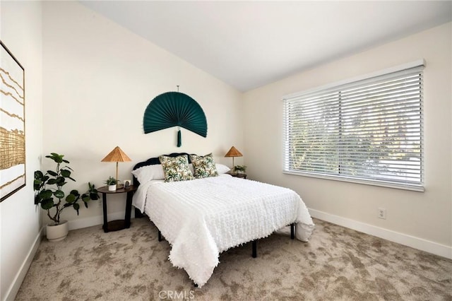 carpeted bedroom with lofted ceiling