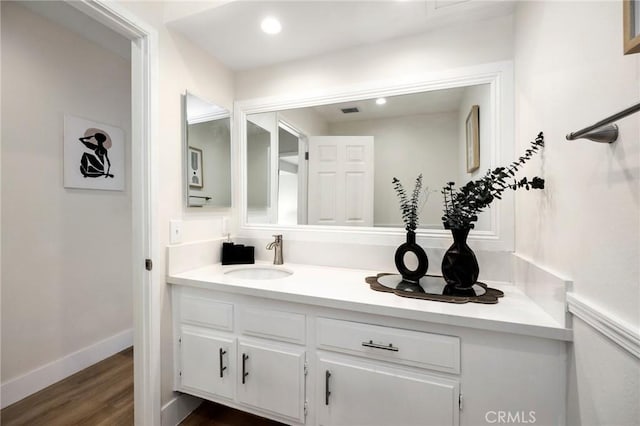 bathroom with hardwood / wood-style floors and vanity