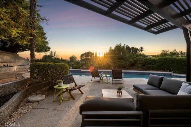 patio terrace at dusk featuring an outdoor living space and a pergola