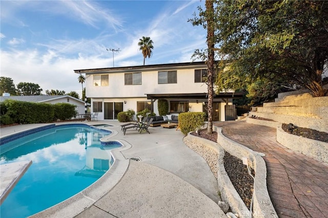 view of pool featuring outdoor lounge area and a patio