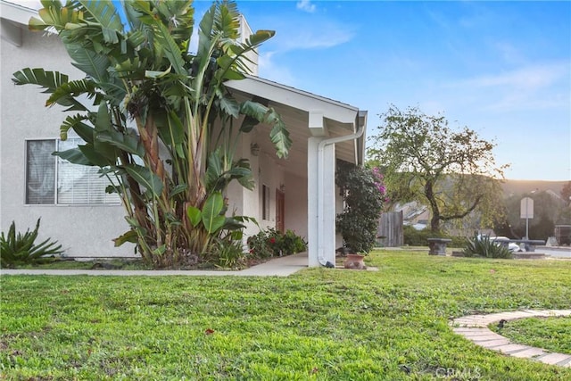 view of side of home featuring a yard