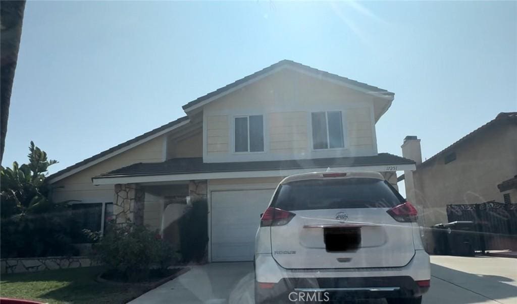 17251 Walnut Ave, Fontana, CA 92336 - view of front facade featuring an attached garage and concrete driveway