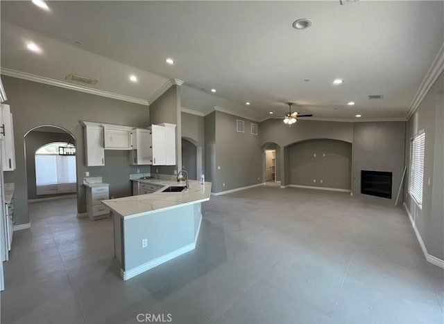 kitchen featuring ornamental molding, sink, white cabinets, and ceiling fan