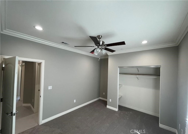 unfurnished bedroom featuring a closet, ceiling fan, ornamental molding, and dark colored carpet