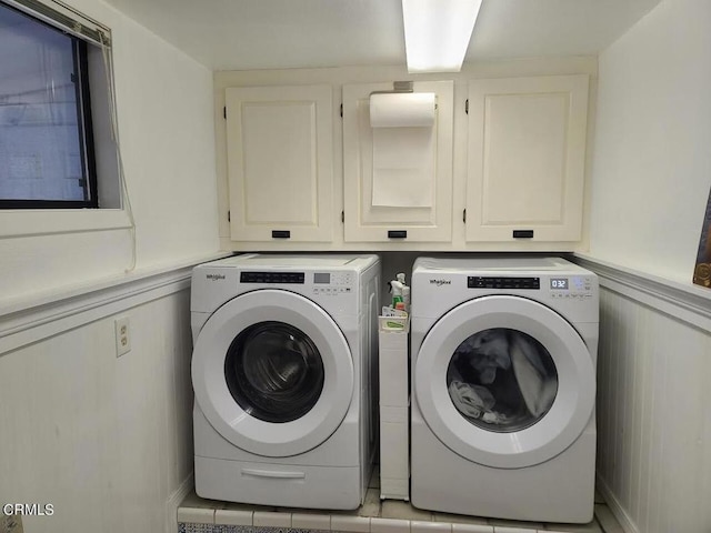 laundry room with washer and dryer and cabinets