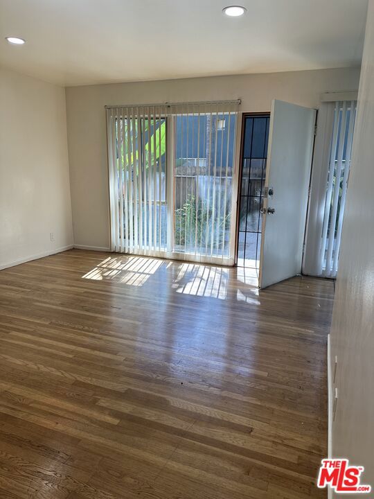 empty room with dark hardwood / wood-style flooring