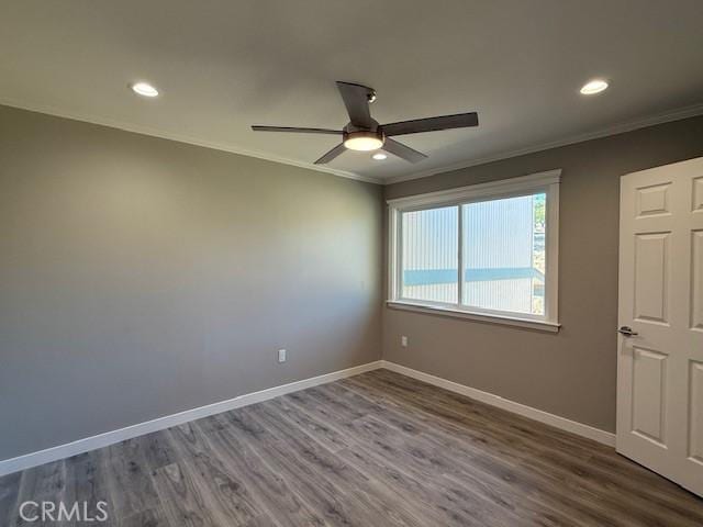 spare room featuring baseboards, ornamental molding, and recessed lighting