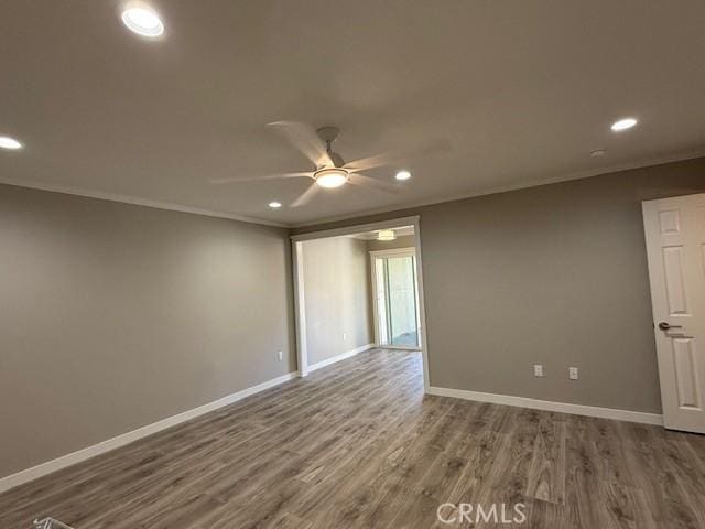empty room with ceiling fan, recessed lighting, baseboards, wood finished floors, and ornamental molding