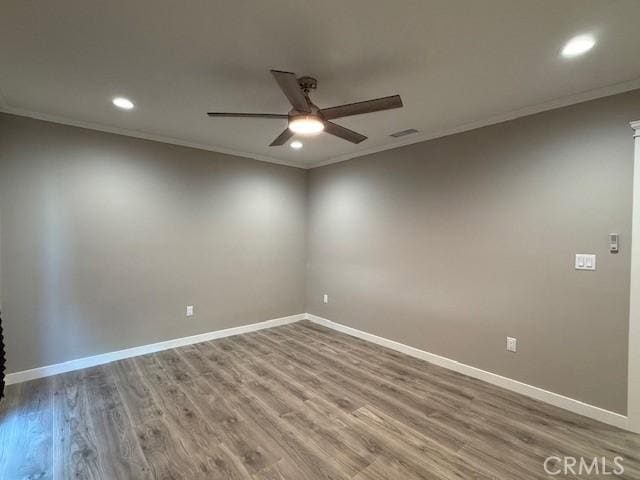 unfurnished room featuring a ceiling fan, wood finished floors, baseboards, ornamental molding, and recessed lighting