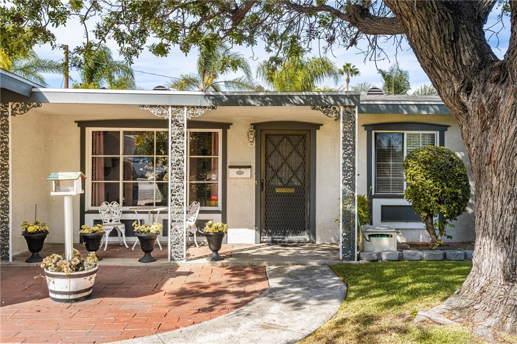 doorway to property featuring a patio