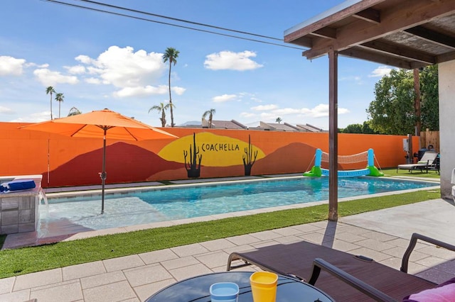 view of pool featuring pool water feature and a patio