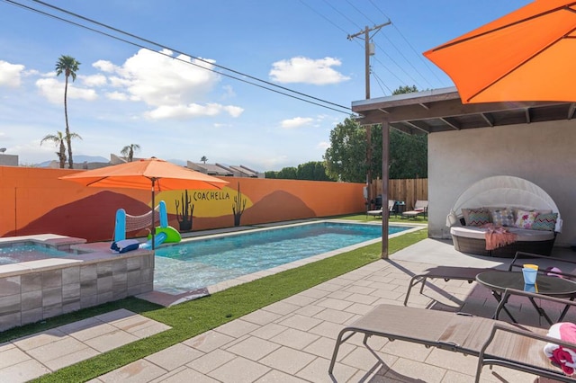 view of pool with an in ground hot tub, a patio, and an outdoor fireplace