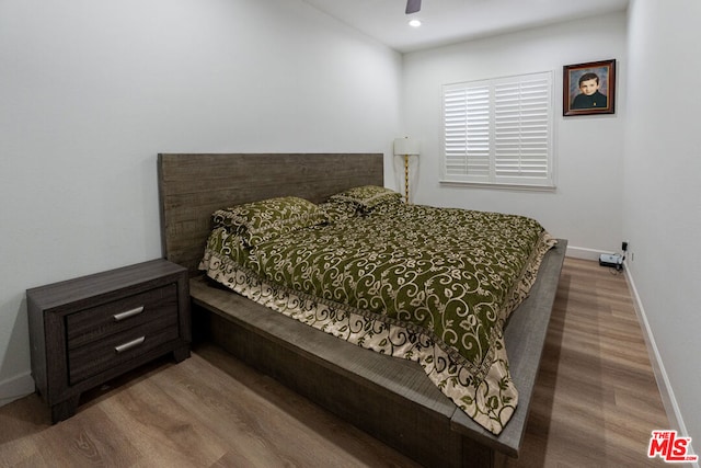 bedroom with ceiling fan and wood-type flooring