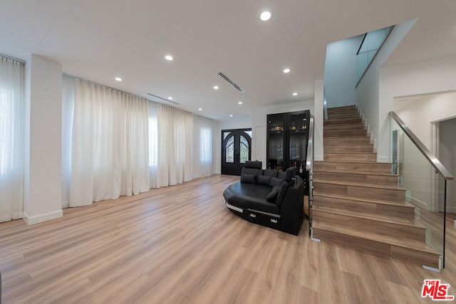 living room with light hardwood / wood-style floors and french doors