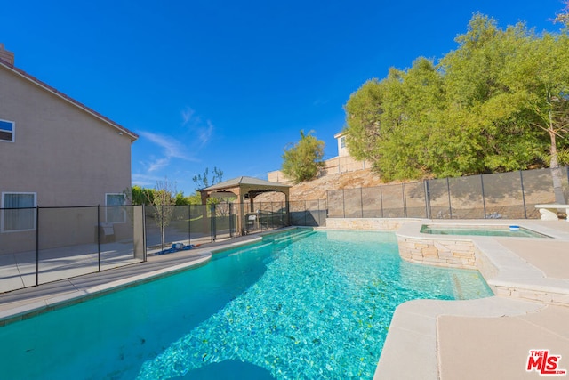 view of swimming pool featuring an in ground hot tub, a patio area, and a gazebo