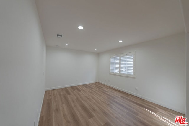 unfurnished room with light hardwood / wood-style floors