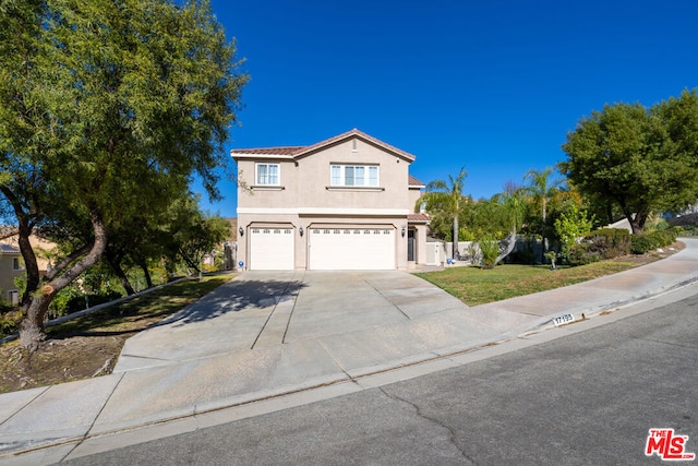 front facade with a front yard and a garage