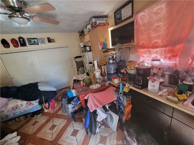 kitchen featuring ceiling fan and a textured ceiling