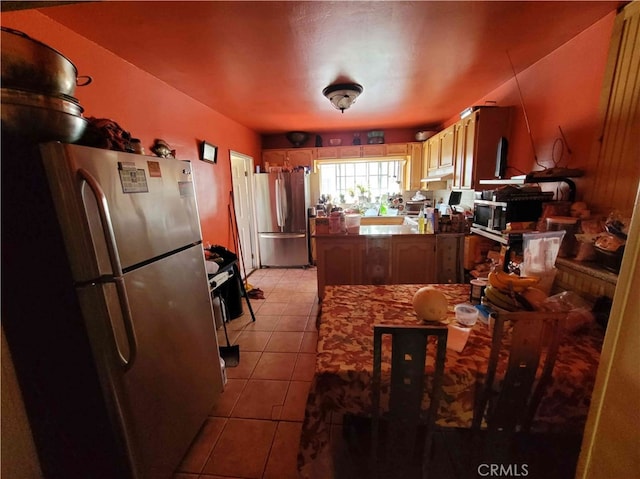 kitchen featuring stainless steel fridge and light tile patterned flooring