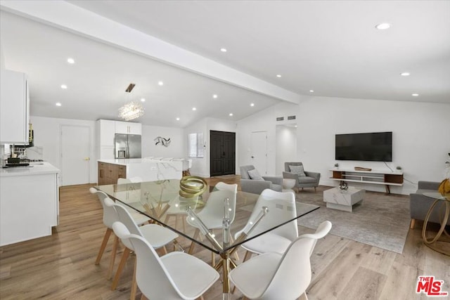 dining area featuring vaulted ceiling with beams and light wood-type flooring