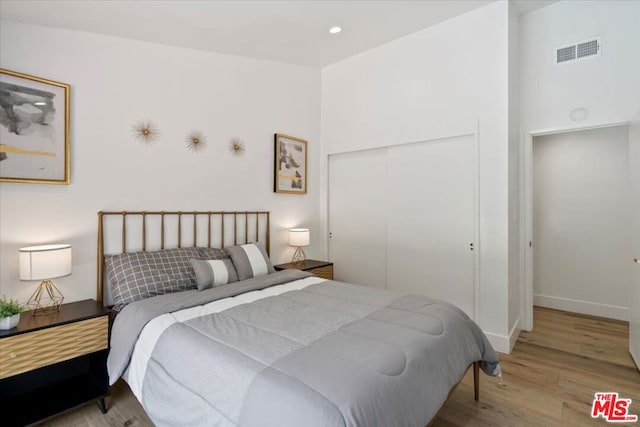 bedroom with a closet and light wood-type flooring