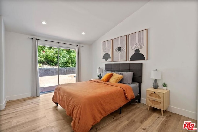 bedroom featuring vaulted ceiling, light wood-type flooring, and access to outside