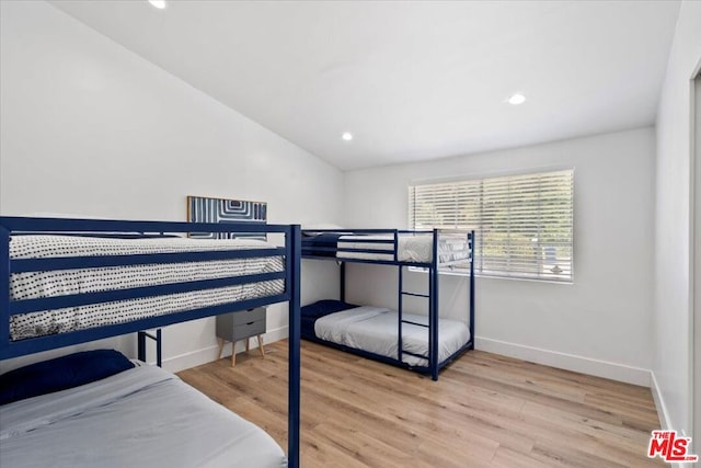 bedroom with wood-type flooring and lofted ceiling