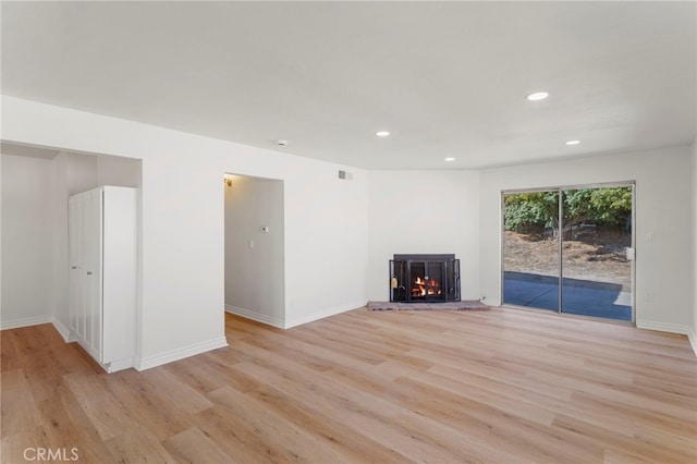 unfurnished living room featuring light wood-type flooring