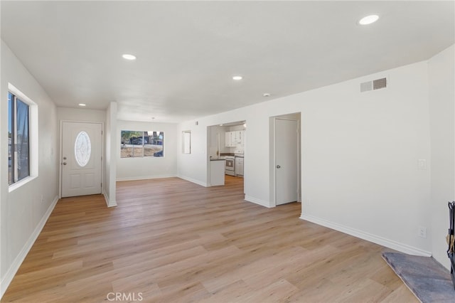 unfurnished living room featuring light hardwood / wood-style floors