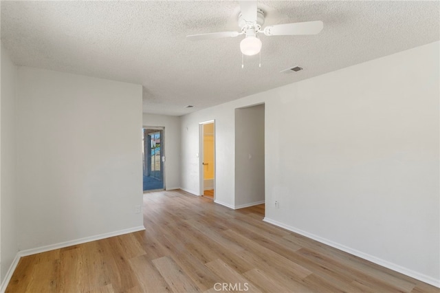 unfurnished room featuring ceiling fan, a textured ceiling, and light wood-type flooring