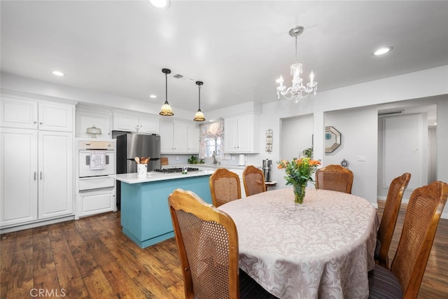 16132 Landmark Dr, Whittier, CA 90604 - dining area featuring dark hardwood / wood-style flooring, a notable chandelier, and sink