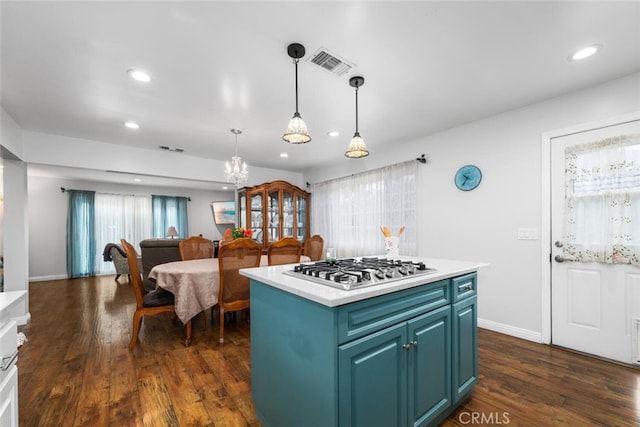 16132 Landmark Dr, Whittier, CA 90604 - kitchen with dark hardwood / wood-style flooring, stainless steel gas cooktop, blue cabinetry, pendant lighting, and a kitchen island