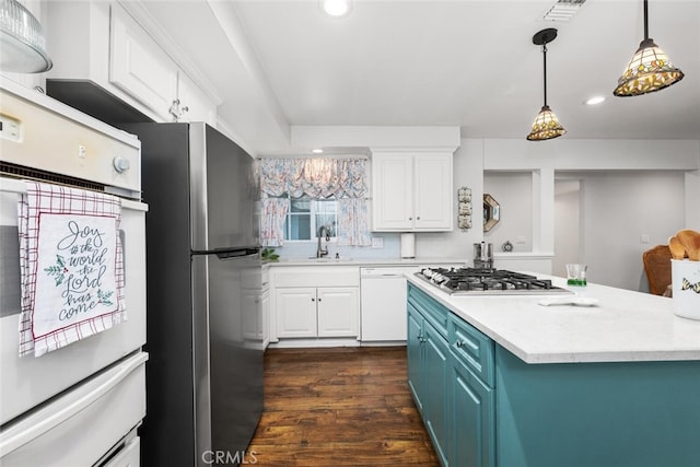 16132 Landmark Dr, Whittier, CA 90604 - kitchen featuring blue cabinetry, dark hardwood / wood-style flooring, white cabinets, and stainless steel appliances