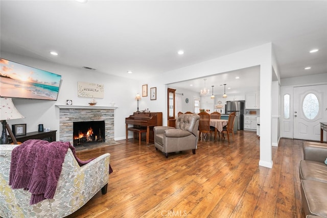16132 Landmark Dr, Whittier, CA 90604 - living room with a stone fireplace and wood-type flooring