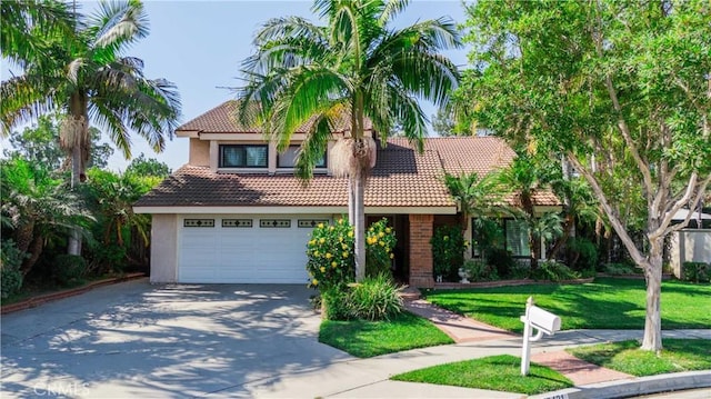 mediterranean / spanish house with a garage and a front lawn