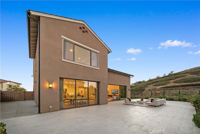 back of property with a patio area and an outdoor hangout area