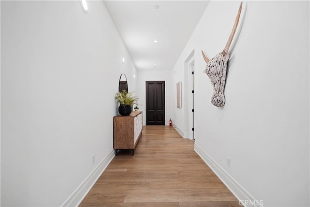 hall with light hardwood / wood-style floors