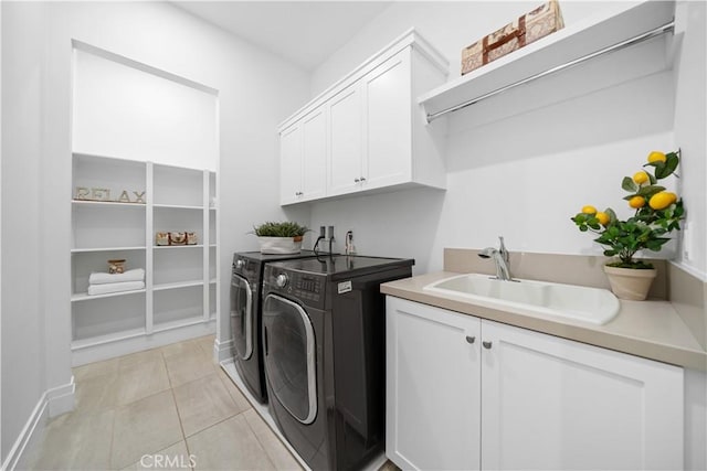 washroom featuring cabinets, independent washer and dryer, sink, and light tile patterned floors