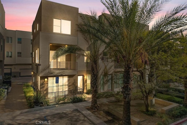 view of front of house featuring a balcony