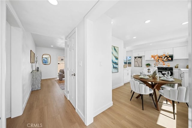 hallway with light hardwood / wood-style floors