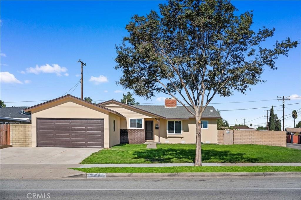 single story home featuring a front yard and a garage