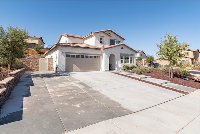 mediterranean / spanish house featuring a garage