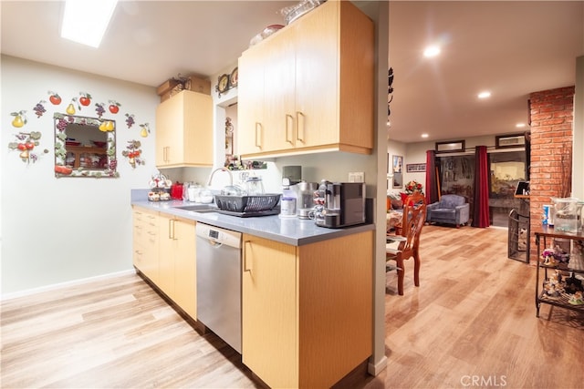 kitchen featuring sink, dishwasher, light brown cabinets, and light hardwood / wood-style floors