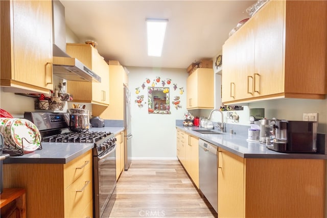 kitchen with wall chimney range hood, light brown cabinetry, light wood-type flooring, sink, and stainless steel appliances