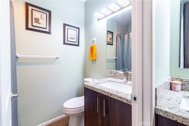 bathroom with vanity, hardwood / wood-style floors, and toilet